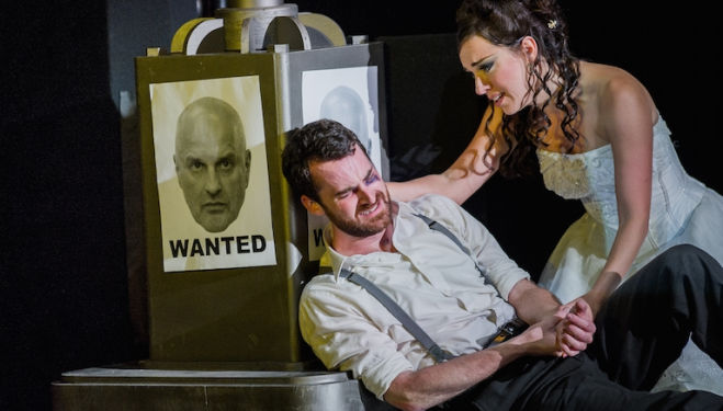 A wanted Don Giovanni (Christopher Purves) looks on as Zerlina (Mary Bevan) consoles Masetto (Nicholas Crawley) in Don Giovanni. Photograph: Robert Workman