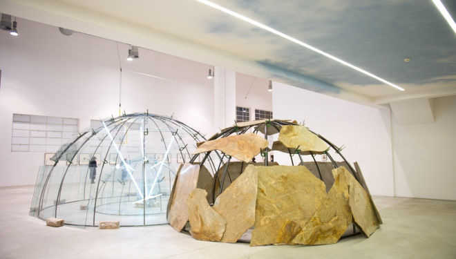 Merz, Mario Movements of the Earth and the Moon on an Axis, 2003 Triple igloo, metal tubes, glass stone, neon, clamps, clay 19’ 7” X 16’ 4” x 9’ 8”, courtesy of Pace