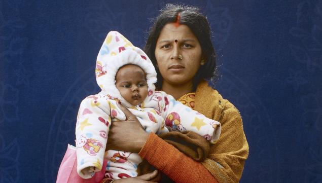 Kumbh Mela Pilgrim - Mamta Dubey and infant by Giles Price, 2013 © Giles Price