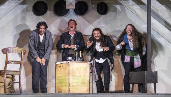 Bohemian artists celebrate a success in Puccini's La Bohème. Photo: Tristram Kenton