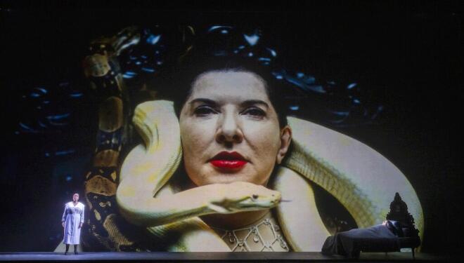 Marina Abramović on screen and Nadine Benjamin on stage in 7 Deaths of Maria Callas. Photo: Tristram Kenton