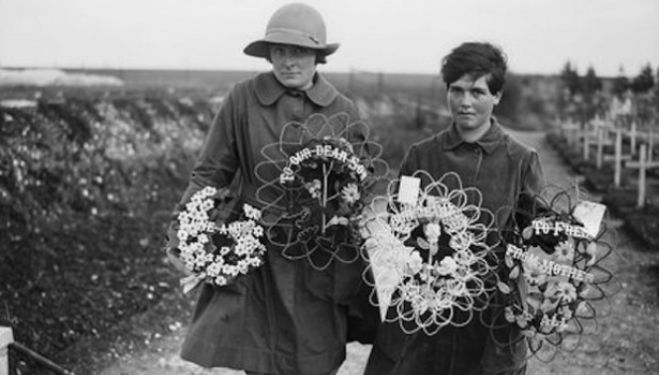 Two members of the Women's Auxiliary Army Corps carrying wreaths